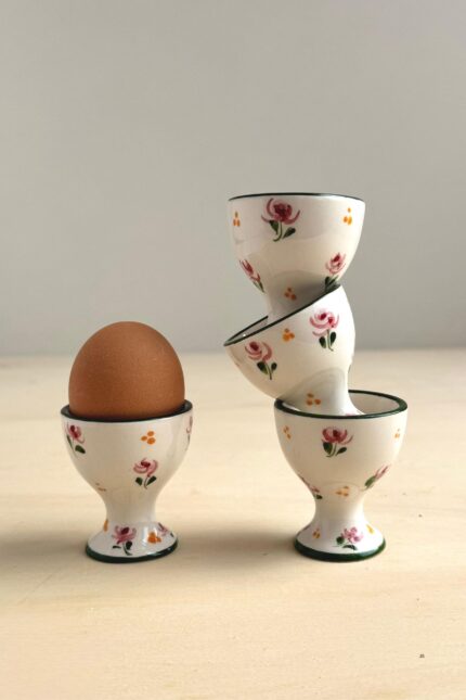 Hand-painted ceramic egg cup from Portugal with delicate pink and green floral design in a romantic vintage style.
