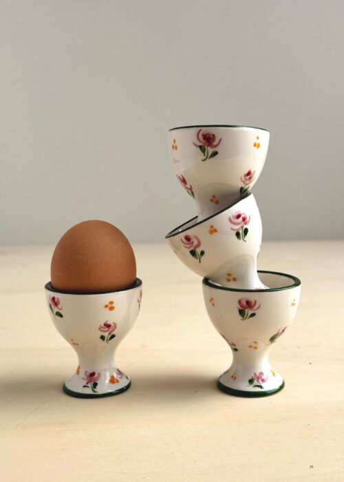 Hand-painted ceramic egg cup from Portugal with delicate pink and green floral design in a romantic vintage style.