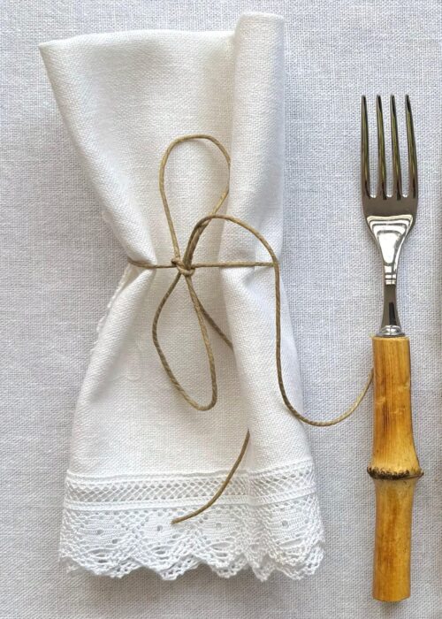 Elegant table setting with Fatima Linen Napkin placed neatly on a dinner plate