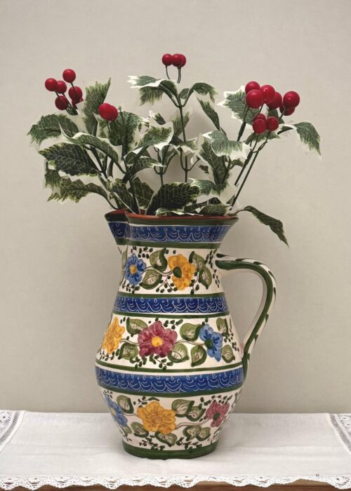 Florinda Clay Jug – hand-painted Portuguese ceramic with floral motifs in blue, yellow, pink, and green, crafted by artisans and used as a decorative vase.